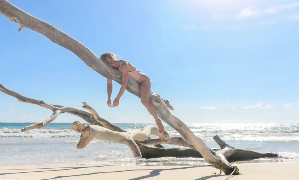 Entreaguas Swim: lying along a driftwood branch on the beach